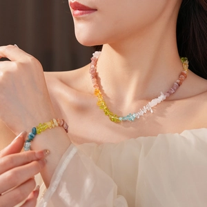 Detail of colorful natural stone bead necklace and bracelet set on a female model