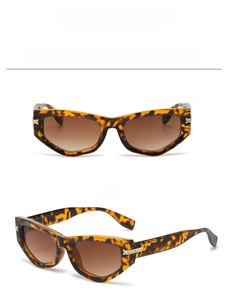 Detail view of tortoiseshell cat eye sunglasses with brown gradient lenses and metal hinges
