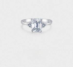 Macro shot of S925 sterling silver ring featuring emerald-cut and trillion-cut cubic zirconia