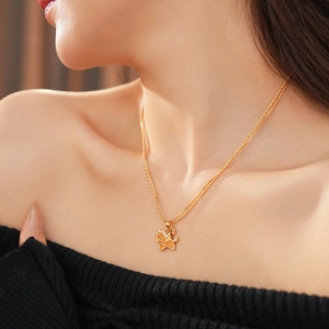 Detailed close-up of a golden double-layered necklace with a unicorn pendant on model