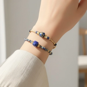 Bohemian blue sodalite beaded bracelets with gold accents styled in layers on wrist
