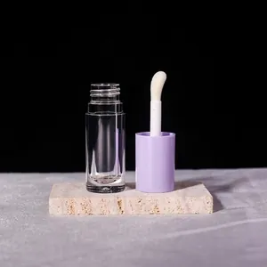 Close-up of a 6ml clear lip gloss tube with a light purple cap and a large applicator brush