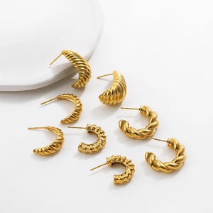 Detailed view of 18K gold plated stainless steel C-shape earrings with textured patterns