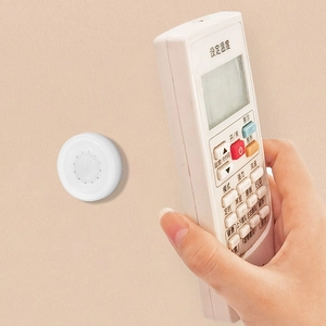 White magnetic wall-mounted holder for remote control and power strips with sleek design