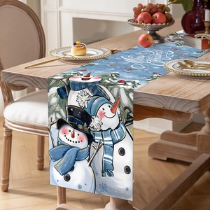 Christmas table runner with three snowmen and Merry Christmas print on wooden table