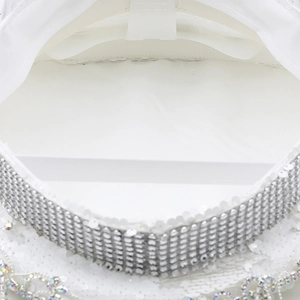Close-up of sparkling sequins and rhinestone flower details on white captain party hat