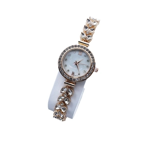 Golden mermaid style women's watch with mother of pearl dial and rhinestone bracelet