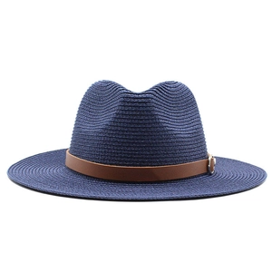 Detail of dark blue woven fedora with brown leather strap and silver buckle accent