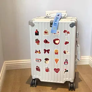 Detail of red cute doodle stickers on a white suitcase showing waterproof texture