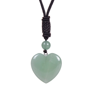 Detailed close-up of heart-shaped green jade pendant with adjustable black cord necklace