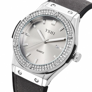 Fashion women's quartz watch with rhinestone bezel and grey suede strap on white background