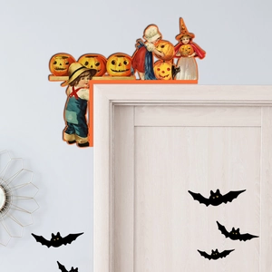 Close-up of Halloween door corner decor featuring trick-or-treaters and pumpkin lanterns