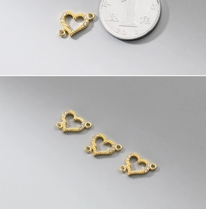 Macro shot of 18k gold plated silver heart connector with small stones for DIY jewelry