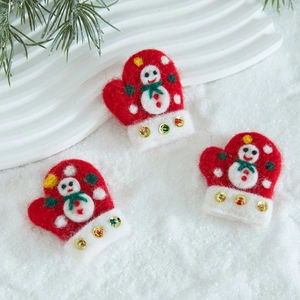 Handmade wool felt Christmas glove ornaments with snowman motifs in festive red and white