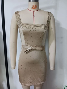 Detail of square neckline with gold sequins and a bow belt on a champagne dress