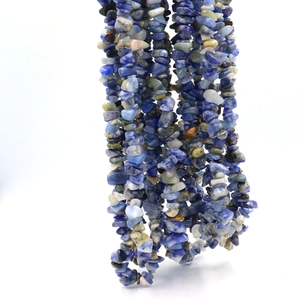 Detailed view of natural blue and grey crushed stone beads with irregular texture