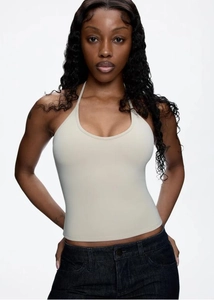 Detailed view of beige halter neck backless top with soft elastic knit fabric