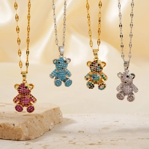 Detail of four micro-paved teddy bear pendant necklaces with sparkling colorful crystals