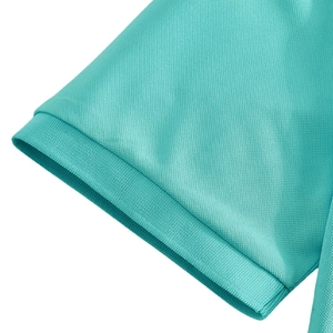 Macro detail of breathable piqué fabric texture on the mint green polo shirt sleeve