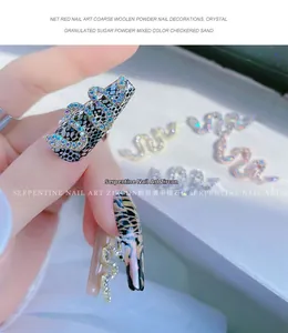 Macro shot of 3D silver snake nail art charms with sparkling zircon and metal finish