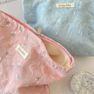 Detail view of the floral jacquard fabric and lining on these Suzakka makeup bags