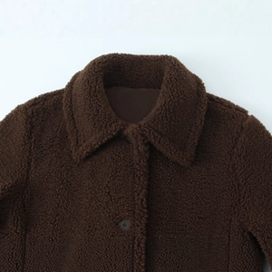 Deep brown sherpa fleece long coat featuring a spread collar and classic button closure
