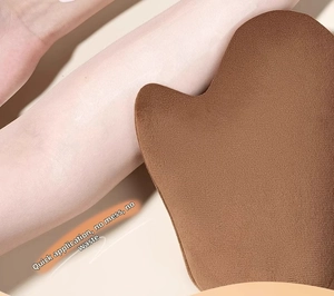 Soft brown velvet tanning mitt applicator showing smooth skin texture on the arm