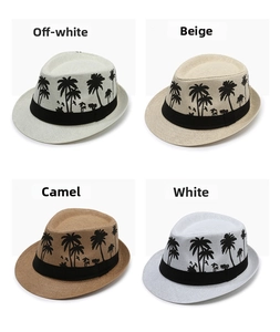 Detail of four colorful sun hats with palm tree prints and black decorative ribbons