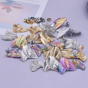 Detailed view of leaf-shaped 304 stainless steel stud earrings in gold, silver, and rainbow