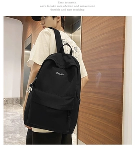 Side view of a large capacity black minimalist backpack on a model in a modern office setting