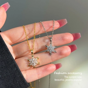 Elegant gold and silver snowflake pendant necklaces with cubic zirconia on fine O-chains