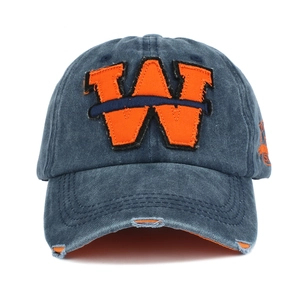 Close-up of vintage washed denim baseball cap with orange W embroidery and distressed detail