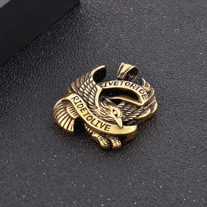 Detailed view of a gold-tone eagle pendant featuring Ride to Live engraved banner design