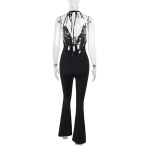 Back view of black halter neck jumpsuit featuring an open back and flared leg design