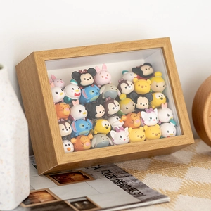Close-up of wooden shadow box display case filled with mini cartoon figure toys