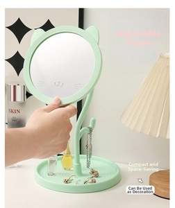 Detail of mint green cat ear makeup mirror with a jewelry storage base and ridged tray