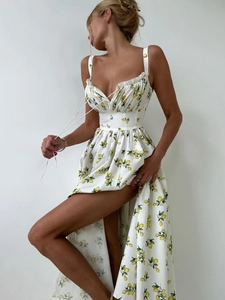 Detail of floral summer dress featuring yellow lemon print and side slit design