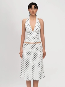 Detailed view of the black polka dot halter top and matching A-line skirt set