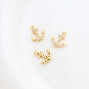 Detailed view of 14k gold-plated anchor pendants with inlaid rhinestones for DIY jewelry