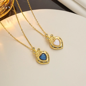 Close-up of gold heart pendants with blue and white stones and sparkling rhinestones