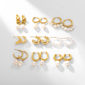 Macro shot of assorted 18K gold stainless steel earrings with pearls and crystals