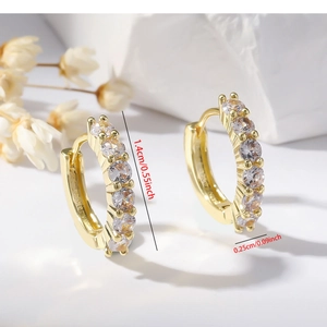 Macro shot showing exact dimensions of gold hoop earrings with clear zircon stones