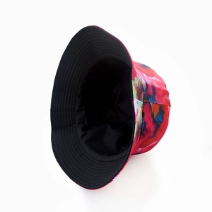 Double-sided tie-dye bucket hat with colorful ink splash pattern and black inner lining