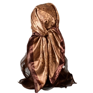 Detailed view of paisley satin headscarf tied on wavy hair with silk-like golden texture