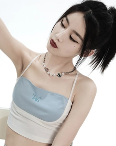 Detailed shot of pearl necklace with a cactus pendant and crystal gems on neck