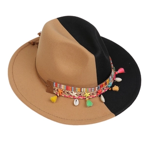 Close-up of bohemian felt hat with ethnic woven band, colorful tassels and shell charms