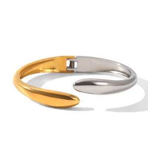 Minimalist two-tone gold and silver stainless steel open bangle in a sleek curved design