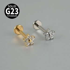 Elegant G23 titanium labret studs with white zircon flower design in gold and silver finish