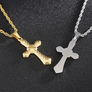 Gold and silver stainless steel cross pendants with rope chains on a black background