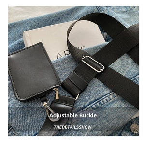 Detail of adjustable fabric shoulder strap with black mini pouch and metal buckle